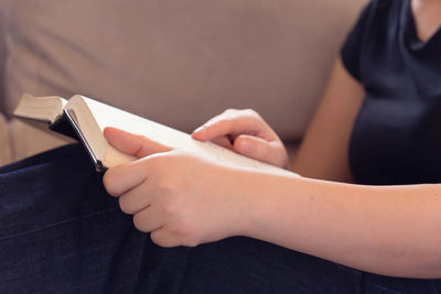 Midsection of woman holding smart phone