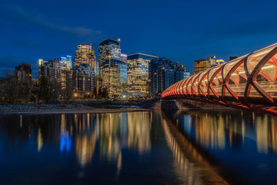 Reflection of illuminated buildings in river at night
