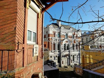 Low angle view of buildings in town against sky