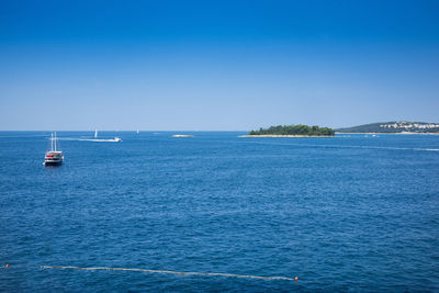 Scenic view of sea against clear blue sky