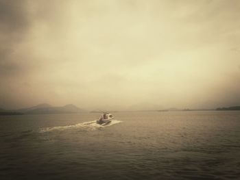 Boats in sea against sky