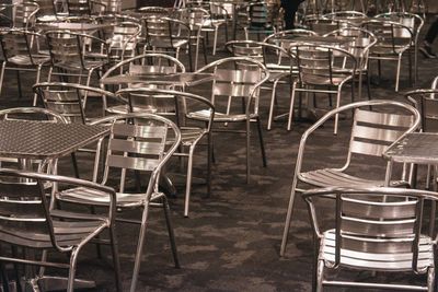 Empty chairs and tables in restaurant