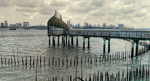 Bridge over river against buildings in city