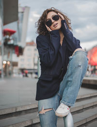 Young woman wearing sunglasses standing outdoors