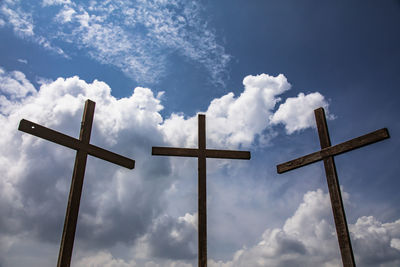 Low angle view of cross against sky