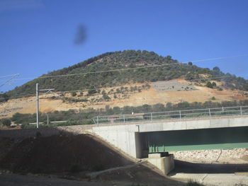 Bridge over river against blue sky