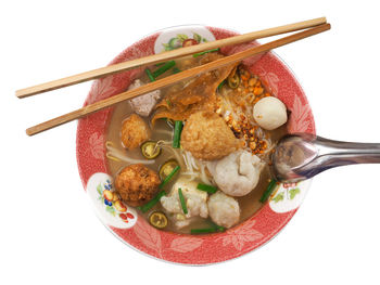 High angle view of vegetables in bowl against white background