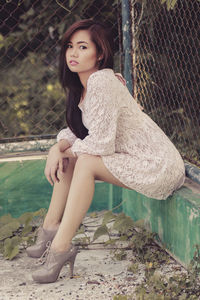 Portrait of young woman sitting outdoors