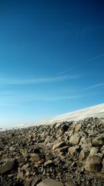 Scenic view of rocky mountains against blue sky