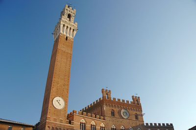 Low angle view of clock tower against sky