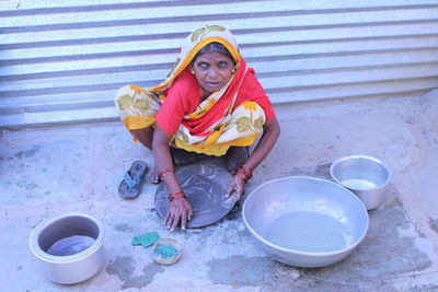 Portrait of a smiling young woman sitting outdoors