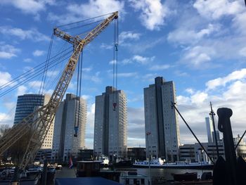 Cranes at construction site against sky