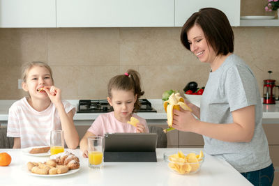People looking away while sitting on table