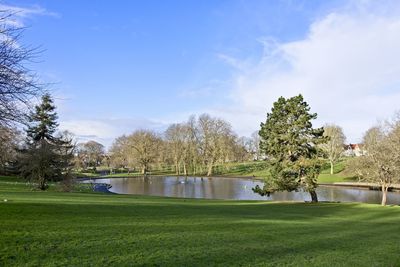Scenic view of golf course against sky