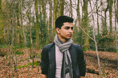 Young man standing in forest