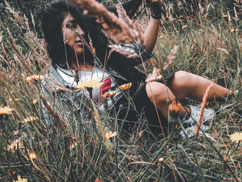 Low section of woman sitting on field