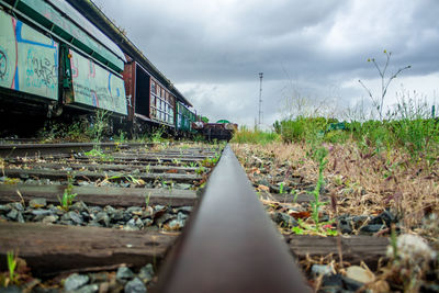 Surface level of train on railroad track against sky