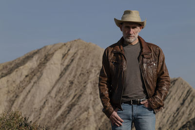 Adult man in cowboy hat in tabernas desert, almeria, spain