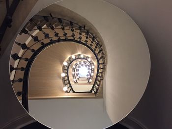 Directly below shot of illuminated spiral staircase