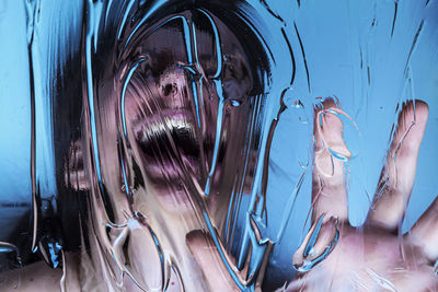 Close-up portrait of woman with reflection in water