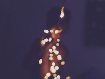 Defocused image of hand holding illuminated lights