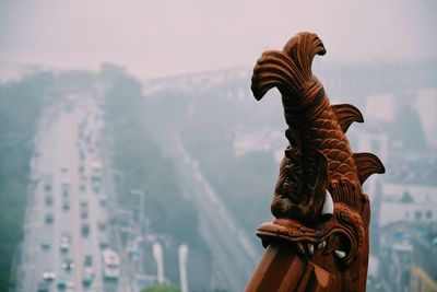 Cropped image of bridge by street against sky