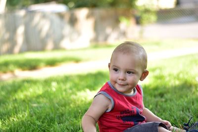 Portrait of smiling boy sitting on grass