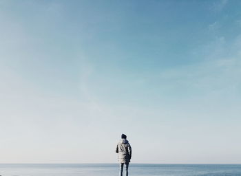 Man standing on beach against sky