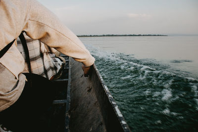 Side view of man standing by sea