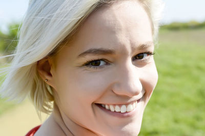 Close-up portrait of smiling young woman