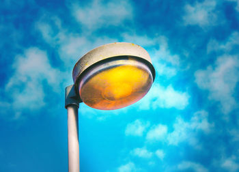 Low angle view of lamp against blue sky
