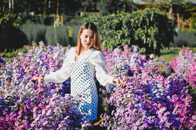 Woman standing on purple flowering plants