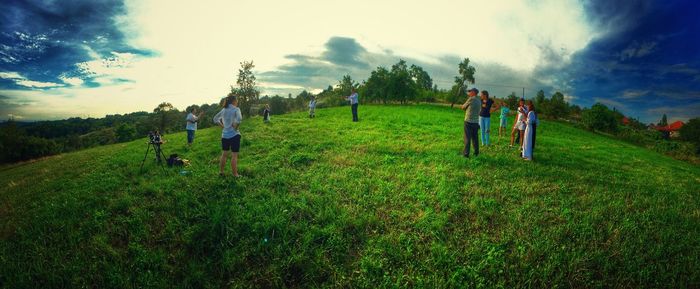 People walking on grassy field