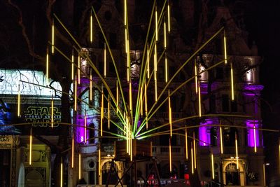 Low angle view of illuminated lights at night