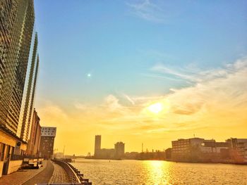 City at waterfront during sunset