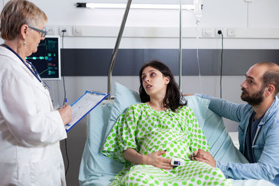 Female doctor examining patient in hospital