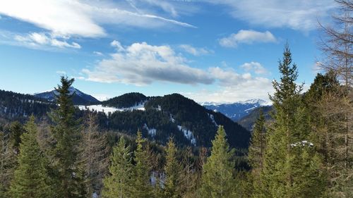 Scenic view of mountains against cloudy sky