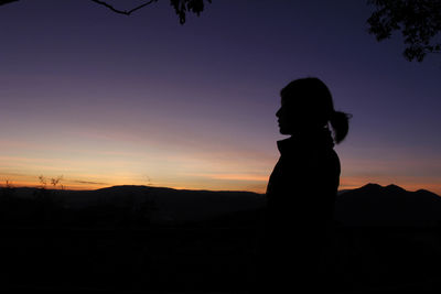 Silhouette man standing against sky during sunset