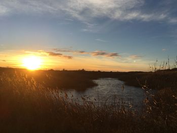 Scenic view of lake against sky during sunset