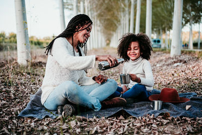 Smiling young woman sitting outdoors