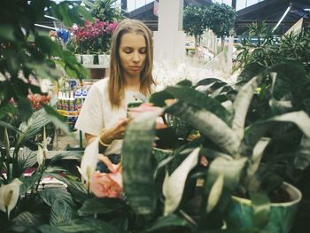 Young woman looking at plants