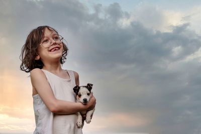 Portrait of happy girl against sky