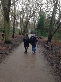 Rear view of woman standing on footpath