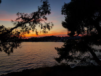 Scenic view of lake against orange sky