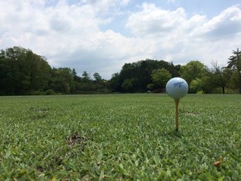 Scenic view of golf course against sky