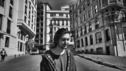 Woman standing on city street