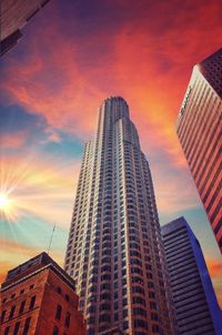 Low angle view of modern building against sky during sunset