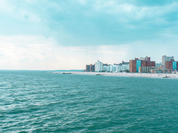 Sea and cityscape against sky