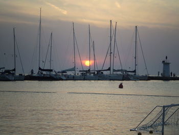 Silhouette of sailboats moored in sea