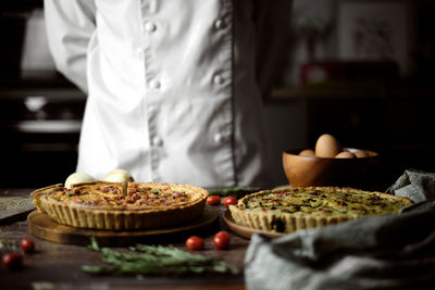 Midsection of man preparing food in restaurant